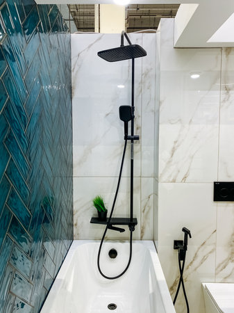 A beautifully designed bathroom that includes both a plush and relaxing bathtub, alongside a convenient shower head, ensuring an enjoyable and refreshing bathing experience for everyoneの写真素材