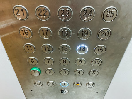This image provides a detailed closeup view of various elevator buttons, with a strong emphasis on the button clearly marked 21, showing its functionality, ease of use, and overall clarityの写真素材