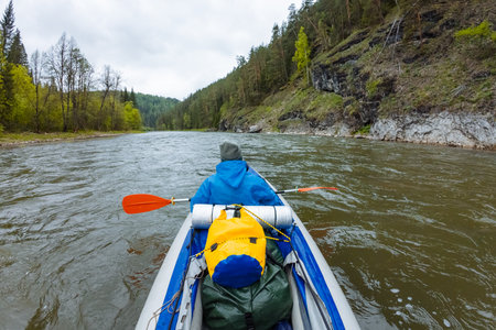 Kayak down a serene river surrounded by lush greenery and impressive cliffs. This adventure is ideal for nature lovers seeking exploration, excitement, and unforgettable discoveriesの写真素材