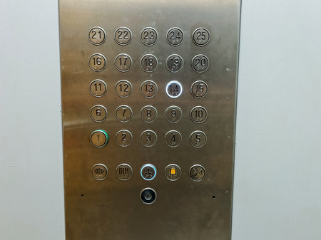 The control panel for the elevator, made of stainless steel, features buttons clearly labeled with...