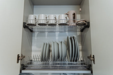 In the kitchen, there exists a cabinet that is fully packed with a diverse assortment of items...