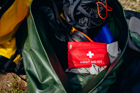 A closeup view of a first aid kit carefully placed among various camping gear, highlighting the critical importance of being safe and well prepared for any outdoor adventure or activity that arisesの写真素材