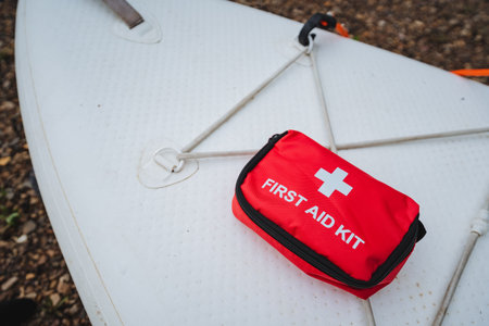 A bright red first aid kit on a paddleboard highlights the importance of having safety gear...