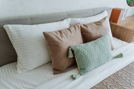 A very comfortable bed that is beautifully adorned with crisp, clean white sheets and fluffy pillows, which have been placed gently and thoughtfully on top of it, creating a cozy atmosphereの写真素材