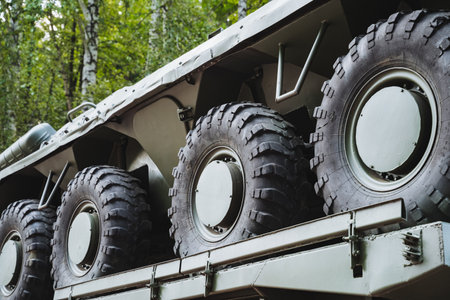 A large collection of tires is located on the rear section of a vehicle, indicating it may be used for various purposes, including transportation.の写真素材