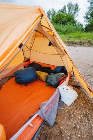 A large tent that is completely filled to the brim with a significant amount of luggage, supplies, and various items meticulously stored inside it, all set and ready for an exciting camping adventureの写真素材