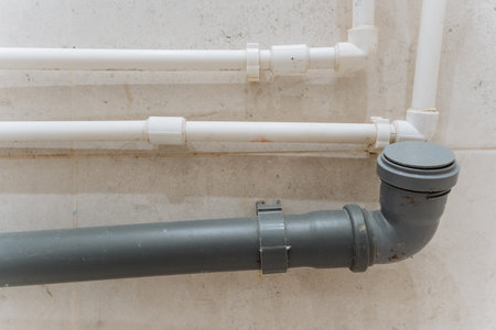 This image displays a welldesigned plumbing system with white PVC and gray pipes, making it an excellent reference for home improvement and plumbing design projects to inspire successful renovationsの写真素材
