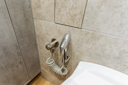 In a stylish bathroom, an ultramodern toilet with a luxurious bidet offers a superior cleaning experience, perfectly complementing the elegant flooring and enhancing the overall aestheticの写真素材