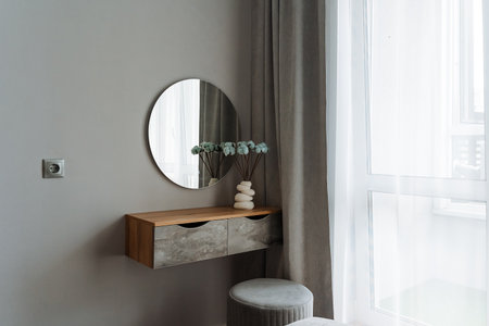 This beautifully designed bedroom features a stylish dresser, an elegant mirror for depth, and a...