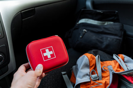 This compact red first aid kit designed specifically for vehicles ensures your safety and preparedness for any possible travel emergencies that may arise during your journeys and adventuresの写真素材