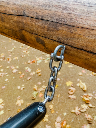 This image prominently features a meticulous closeup view of a sturdy metal chain that is securely...