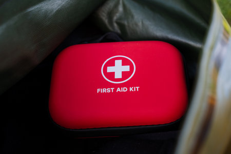 A bright red first aid kit in a sturdy backpack is essential for outdoor enthusiasts. Its perfect...