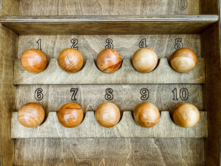 This wooden tray features numbered balls from 1 to 10, ideal for vintage decor lovers and game enthusiasts, showcasing exceptional craftsmanship and rustic charm that reflects traditional artistryの写真素材