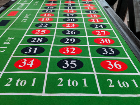 A vibrant green roulette table with red and black numbers creates an exciting ambiance, inviting players to immerse themselves in the game of chance and luckの写真素材