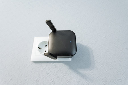 This modern wireless range extender boasts a compact design with an antenna, perfect for enhancing WiFi signals in your home or office and ensuring seamless internet access throughoutの写真素材