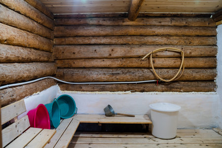 Step into a beautifully crafted wooden sauna with vibrant basins and wellness tools designed to promote relaxation, rejuvenation, and enhance your overall health and wellness experienceの写真素材