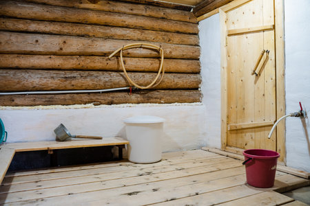 A cozy rustic cabin interior with wooden logs, a practical basin, and charming decor, capturing the essence of country living and tranquility, inviting you to enjoy its peaceful atmosphereの写真素材