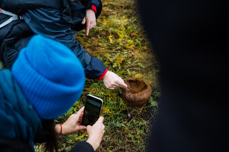 friends documenting nature discoveries, friends capturing spontaneous nature moments outdoorsの写真素材