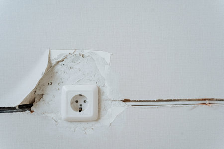 wall outlet installed, outlet fitted into drywall, installed outlet with drywall grooves and patchの写真素材