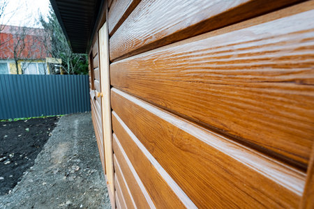 inspect door for winter readiness, homeowner examines door threshold for winter preparation, homeowner thoroughly inspects door seals and thresholds to ensure winter readiness and protectionの写真素材
