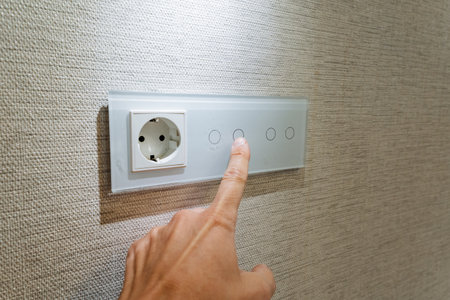 fingertip interacts with luminous panel, modern apartment lighting via finger touch interaction,...