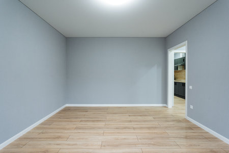 This cozy room with stylish gray walls and modern wood flooring is perfect for gathering design...