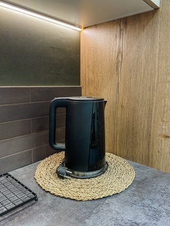 Quiet kitchen with kettle setup, Stylish kitchen nook with electric kettle and decorative accents,...