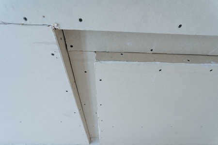 closeup of drywall corners and screw alignment, detailed view of drywall surface with screwsの写真素材