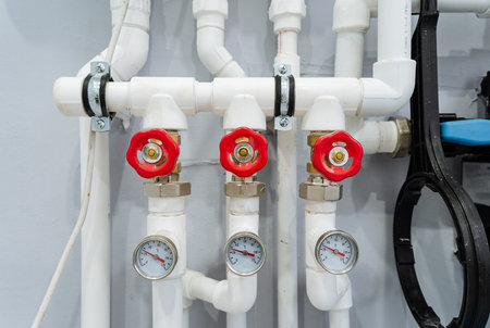 precise control valves and fittings, detailed view of red control valves with gauges and fittingsの写真素材