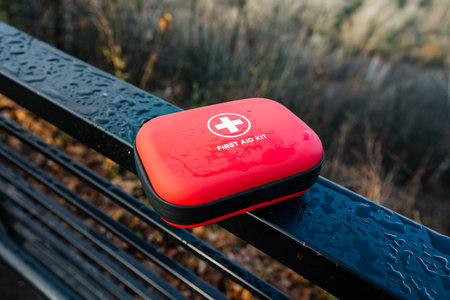 Emergency kit accessible, Quick access first aid container with reflective droplets and clear symbols, Zippered EVA case featuring red cross for rapid identification and safetyの写真素材