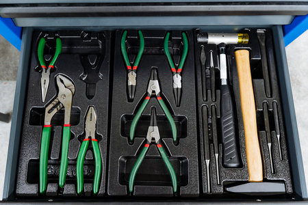 Professional Mechanic Organizing Tools, Efficient Industrial Garage Tool Arrangement, Neatly Arranged Metal Toolbox Displaying Essential Professional Tools In Industrial Settingの写真素材