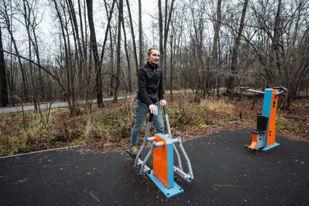 urban gym session, person boosts energy by exercising outdoors in urban park setting, individual...