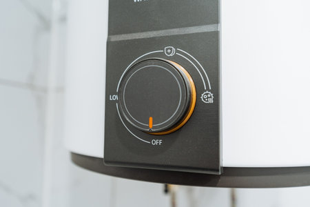 Control Dial Set To Medium On Water Heater With Clear Markings And Energy Icon, Closeup Of Knob Shows Calibration, Eco Setting, And Modern Appliance Interface For Energy Efficient Smart Home Messagingの写真素材