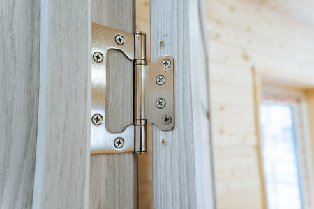 Close View Of Hinge On Wooden Door, Interior Door Frame Emphasizing Quality Hinge Installation, Focus On Metal Hinge Attached To Wooden Door Frame Showcasing Craftsmanship And Durabilityの写真素材