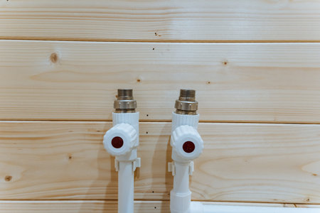 Two Radiator Valves On Wooden Wall, White Pipes With Brass Connectors, Red Control Knobs Closeup Detail Of Heating Plumbing, Rustic Interior Texture, MaintenanceReady Setup Suitable For Inspectionの写真素材