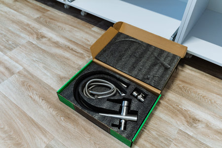 Faucet Parts On Floor Ready For Plumbing Install, Chrome Connectors And Flexible Hose Arranged In...