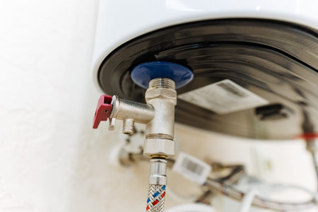 Closeup Valve And Pipe Connection, Detailed View Of Metal Valve Body, Braided Hose And Threaded...