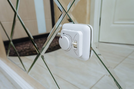 Portable White Electric Freshener Affixed To Mirror Tiles Showcasing Sparkling Reflections And...