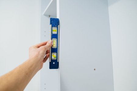 Installer Verifies Vertical Level Accuracy. Ensuring Precise Bubble Placement On Surface. Handheld...
