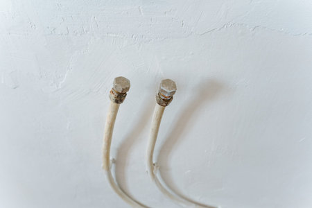 Two Exposed Coaxial Cable Ends On Plaster Raw Home Renovation Detail Showing Loose Metal Connectors...