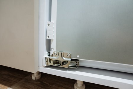 Closeup Fridge Hinge And Base Showing Metal Mechanism And Floor Mounting, Technician Inspection Vibe...