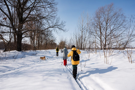Hikers In Snow. Adventurers Navigating Frosty Terrain With Shared Purpose And Supplies. Two Outdoor Enthusiasts Collaboratively Traversing Icy Fields With Gear And Clear Directionの写真素材