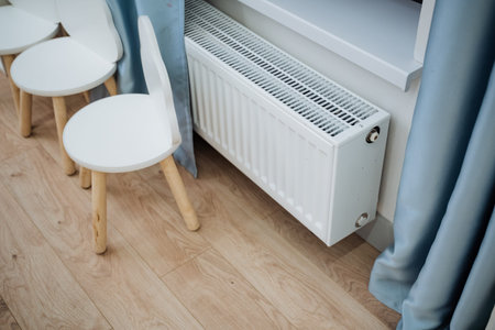 Radiator Under Window With Chairs, Light Wood Floor, Pale Blue Curtain, Compact White Panel Heater,...