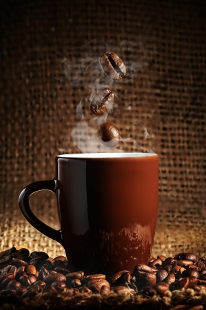 brown cup of coffee with coffee beansの写真素材