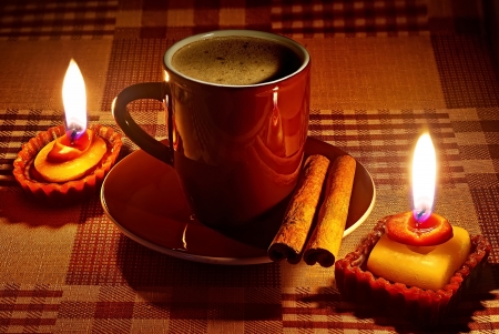 Cup of coffee in natural candle lighting の写真素材
