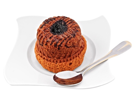 cupcake on white plate, isolated on white with spoon on the sideの写真素材