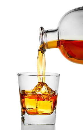 whiskey being poured into a glassの写真素材