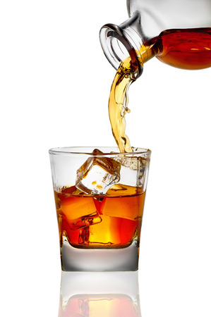 whiskey being poured into a glassの写真素材