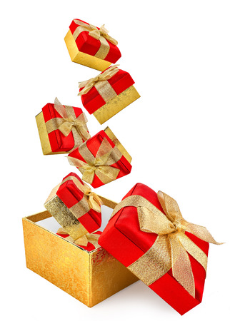 flying red gift boxes cut out from whiteの写真素材