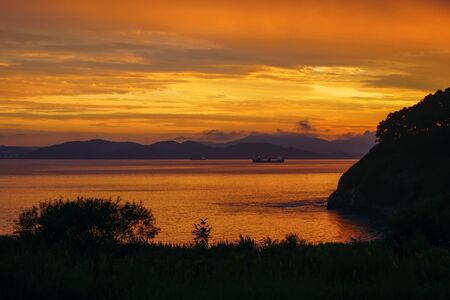 Beautiful golden landscape in the sea bay after sunsetの写真素材